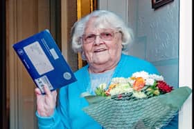 Ethel Ashworth with her telegram from the Queen, and the flowers given to her on behalf of Trawden Forest Friendship Group