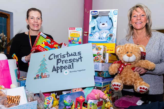 Pictured with just some of the fantastic presents for the Burnley Christmas Toy Appeal are Alicia Foley, Community Investment Manager at Calico Homes (left) and Lynne Blackburn, Project Manager at Participation Works.