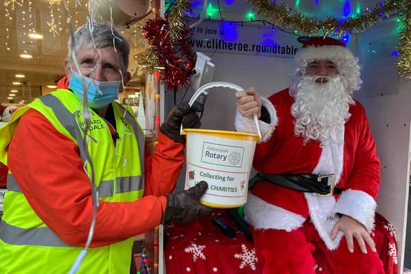 Pictured is Santa handing a very full bucket to Ribblesdale Rotary’s Club Treasurer Richard Dugdale