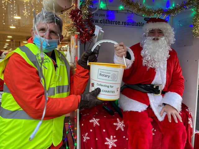 Pictured is Santa handing a very full bucket to Ribblesdale Rotary’s Club Treasurer Richard Dugdale