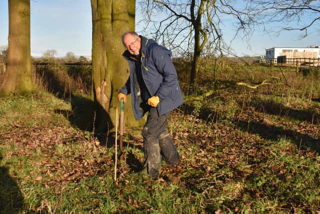 Armed with a spade, Clitheroe Rotarian Mark Woodward plants trees to save the planet