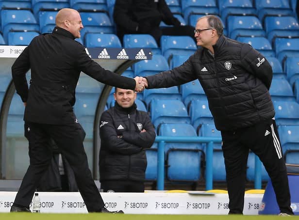 Burnley's English manager Sean Dyche (L) and Leeds United's Argentinian head coach Marcelo Bielsa (R) shake hands ahead of the English Premier League football match between Leeds United and Burnley at Elland Road on December 27, 2020.