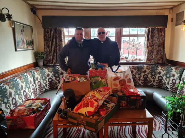 Lee Mortimer of the Hare and Hounds (left) hands over some of the food donated to Pastor Mick Fleming of Church on the Street