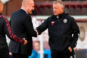 Burnley's English manager Sean Dyche (C) greets Sheffield United's English manager Chris Wilder (R) ahead of the English League Cup second round football match between Burnley and Sheffield United at Turf Moor in Burnley, north west England on September 17, 2020.