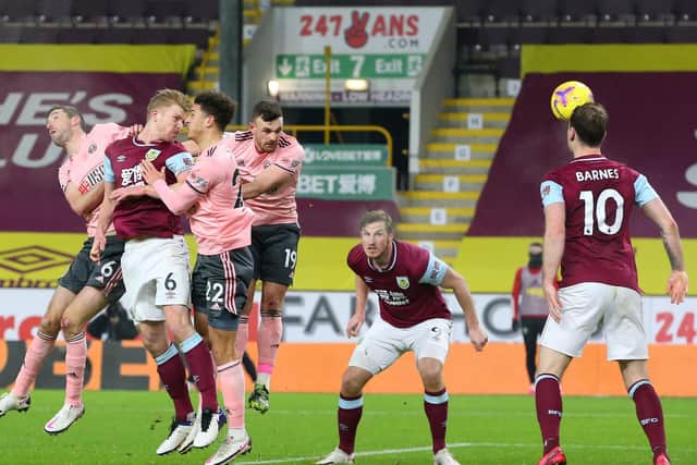 Ben Mee of Burnley scores his team's first goal during the Premier League match between Burnley and Sheffield United at Turf Moor on December 29, 2020 in Burnley, England.