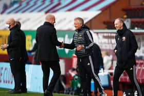 Sean Dyche, Manager of Burnley and Chris Wilder, Manager of Sheffield United shake hands prior to the Premier League match between Burnley FC and Sheffield United at Turf Moor.