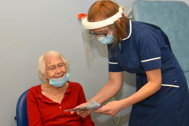 A historic moment as Mrs Barbara Lawton is the first patient in Clitheroe to receive the Covid-19 vaccine by nurse Carole Kay. Picture by David Bleazard