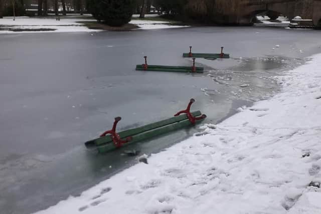 The sad and shocking image of the upturned benches in the lake at Thompson Park in Burnley has caused outrage in the town. (photo by Andy Robinson)