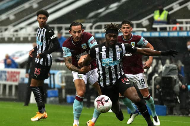 Allan Saint-Maximin of Newcastle United is challenged by Josh Brownhill of Burnley and Ashley Westwood of Burnley during the Premier League match between Newcastle United and Burnley at St. James Park on October 03, 2020.