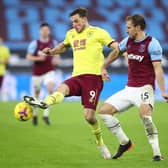 Chris Wood of Burnley is challenged by Craig Dawson of West Ham United during the Premier League match between West Ham United and Burnley at London Stadium on January 16, 2021 in London, England.