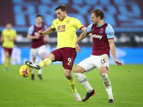 Chris Wood of Burnley is challenged by Craig Dawson of West Ham United during the Premier League match between West Ham United and Burnley at London Stadium on January 16, 2021 in London, England.