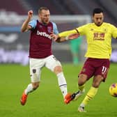Vladimir Coufal of West Ham United battles for possession with Dwight McNeil of Burnley during the Premier League match between West Ham United and Burnley at London Stadium on January 16, 2021 in London, England.