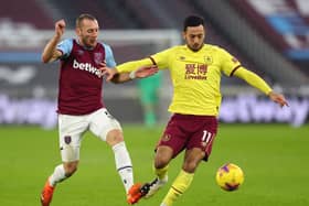 Vladimir Coufal of West Ham United battles for possession with Dwight McNeil of Burnley during the Premier League match between West Ham United and Burnley at London Stadium on January 16, 2021 in London, England.