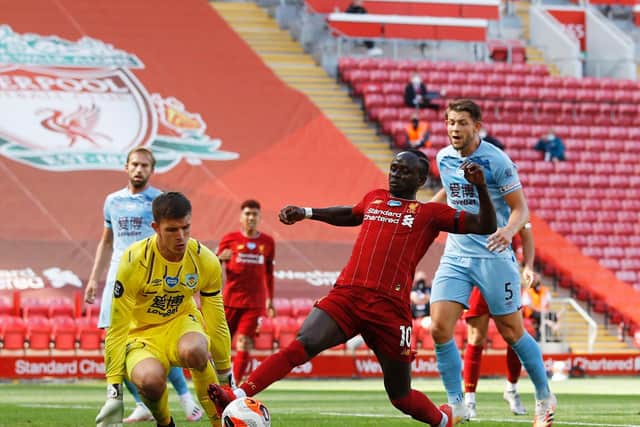 Liverpool's Senegalese striker Sadio Mane (2R) tries to get the ball past Burnley's English goalkeeper Nick Pope during the English Premier League football match between Liverpool and Burnley at Anfield in Liverpool, north west England on July 11, 2020.
