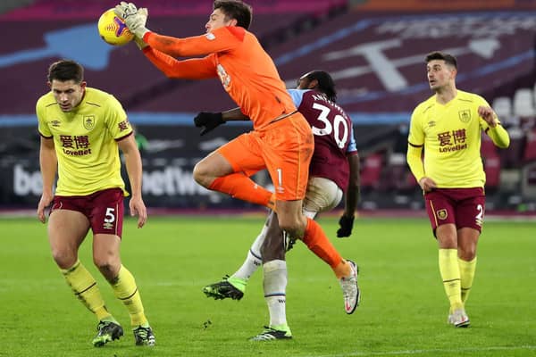 Nick Pope of Burnley collects the ball under pressure from Michail Antonio of West Ham United during the Premier League match between West Ham United and Burnley at London Stadium on January 16, 2021 in London, England.