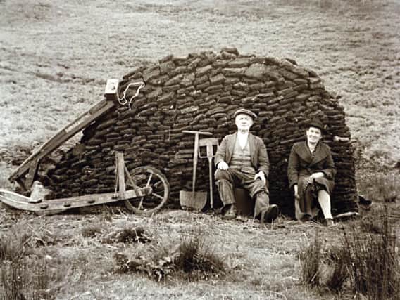 Leonard and Janet Leeming of Slaidburn with their turf along with their turf barrow, sled and spades on Croasdale Fell in the 1950s