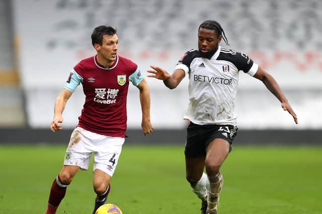 Jack Cork of Burnley is challenged by Josh Onomah of Fulham during The Emirates FA Cup Fourth Round match between Fulham and Burnley at London Stadium on January 24, 2021 in London, England.