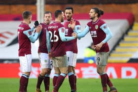 Jay Rodriguez (R) of Burnley celebrates with Dwight McNeil and team mates after scoring their side's second goal during The Emirates FA Cup Fourth Round match between Fulham and Burnley at Craven Cottage on January 24, 2021 in London, England.