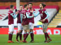 Jay Rodriguez (R) of Burnley celebrates with Dwight McNeil and team mates after scoring their side's second goal during The Emirates FA Cup Fourth Round match between Fulham and Burnley at Craven Cottage on January 24, 2021 in London, England.