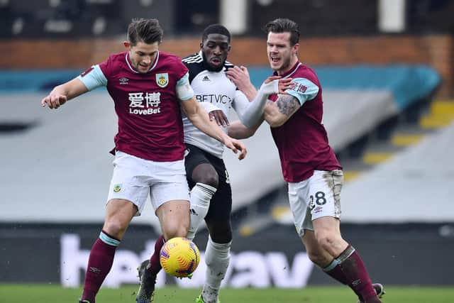 Burnley's English defender James Tarkowski (L) and Burnley's Irish defender Kevin Long (R) tackle Fulham's French striker Aboubakar Kamara (C) during the English FA Cup fourth round football match at Craven Cottage in west London on January 24, 2021.