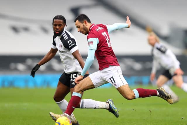 Dwight McNeil of Burnley looks to break past Josh Onomah of Fulham during The Emirates FA Cup Fourth Round match between Fulham and Burnley at Craven Cottage on January 24, 2021 in London, England.
