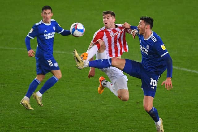 Nathan Collins of Stoke City is challenged for the ball by Kieffer Moore of Cardiff City during the Sky Bet Championship match between Stoke City and Cardiff City at Bet365 Stadium on December 08, 2020 in Stoke on Trent, England.