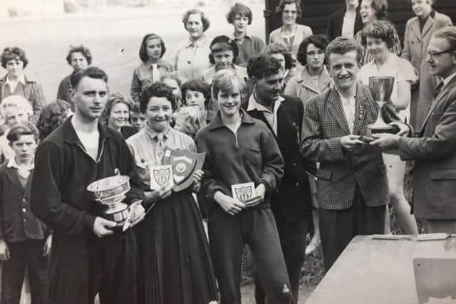 Joyce ( centre) pictured in the 1960s with a Burnley Youth Sports Association award at Lower Towneley playing fields
