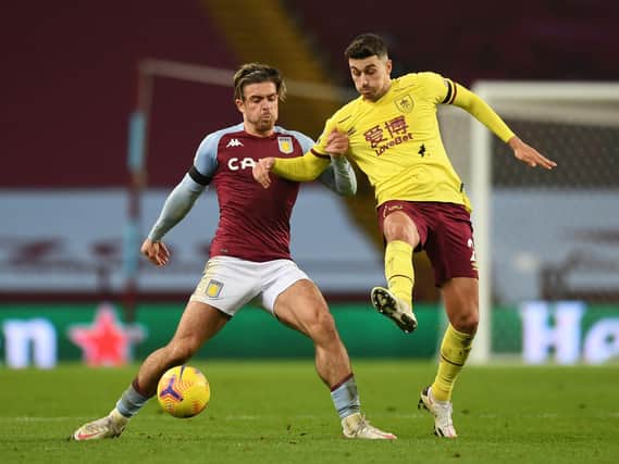 Jack Grealish of Aston Villa battles for possession with Matthew Lowton of Burnley during the Premier League match between Aston Villa and Burnley at Villa Park on December 17, 2020 in Birmingham, England.