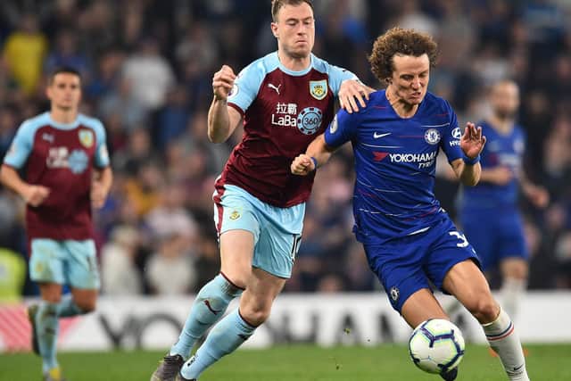 Burnley's English striker Ashley Barnes (CR) vies with Chelsea's Brazilian defender David Luiz (R) during the English Premier League football match between Chelsea and Burnley at Stamford Bridge in London on April 22, 2019.