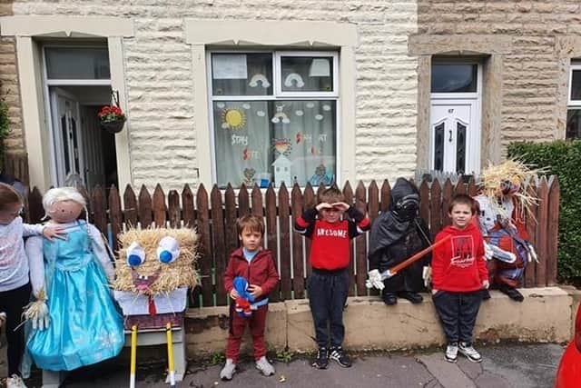 Youngsters admiring some of the scarecrow displays created by residents in Rosegrove