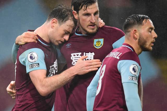 Burnley's English striker Ashley Barnes (L) celebrates with Chris Wood (C) after scoring the first goal during the Premier League match between Burnley and Wolverhampton Wanderers at Turf Moor in Burnley, north west England on December 21, 2020.