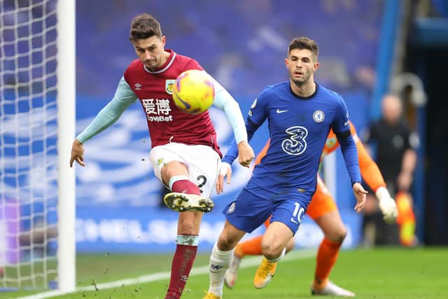 Burnley's English defender Matthew Lowton clears the ball from Chelsea's US midfielder Christian Pulisic during the English Premier League football match between Chelsea and Burnley at Stamford Bridge in London on January 31, 2021.