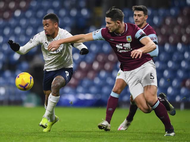 Gabriel Jesus of Manchester City battles for possession with James Tarkowski of Burnley during the Premier League match between Burnley and Manchester City at Turf Moor on February 03, 2021 in Burnley, England.