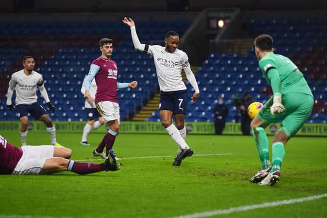Raheem Sterling of Manchester City scores their side's second goal past Nick Pope  during the Premier League match between Burnley and Manchester City at Turf Moor on February 03, 2021 in Burnley, England.