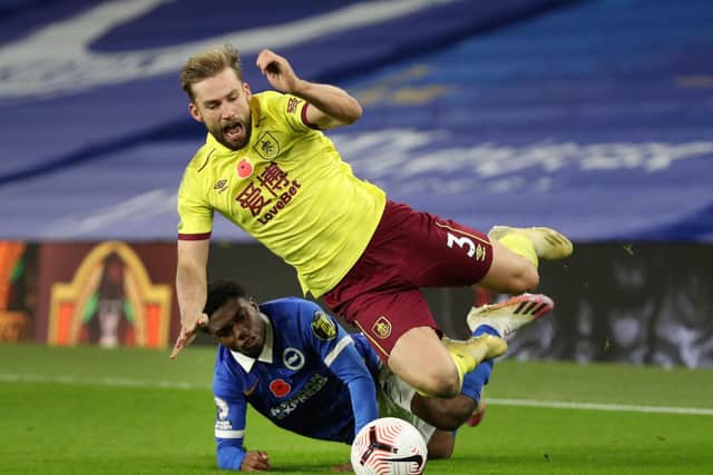 Brighton's English midfielder Tariq Lamptey tackles Burnley's English defender Charlie Taylor during the English Premier League football match at the American Express Community Stadium in Brighton, southern England on November 6, 2020.