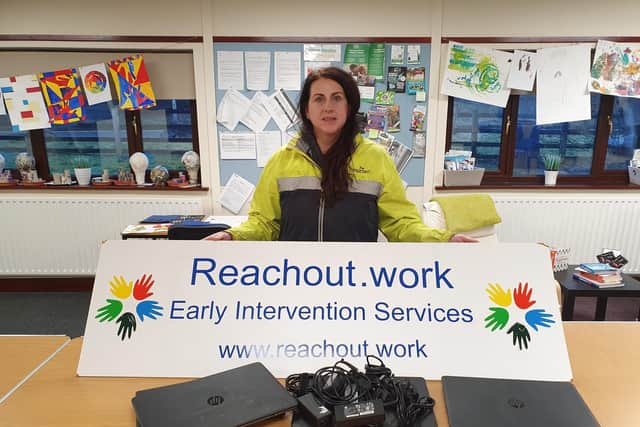 Managing director of Reachout.work Karen Lynch accepts Rapid IT’s donation of laptops for the charity.