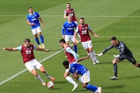 Nick Pope of Burnley shouts at his defenders as James Tarkowski of Burnley clears the ball during the Premier League match between Burnley FC and Brighton & Hove Albion at Turf Moor on July 26, 2020 in Burnley, England.