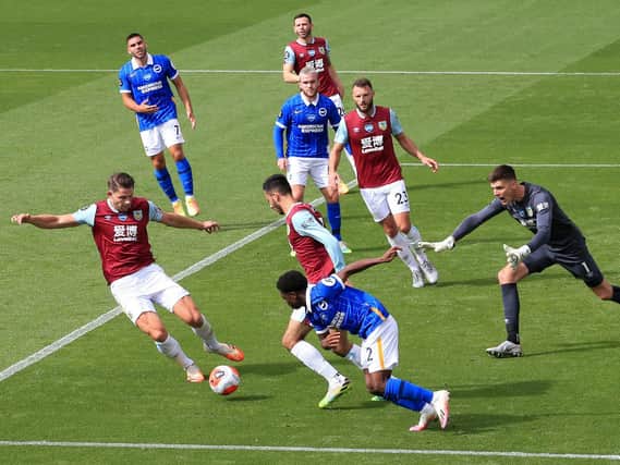 Nick Pope of Burnley shouts at his defenders as James Tarkowski of Burnley clears the ball during the Premier League match between Burnley FC and Brighton & Hove Albion at Turf Moor on July 26, 2020 in Burnley, England.
