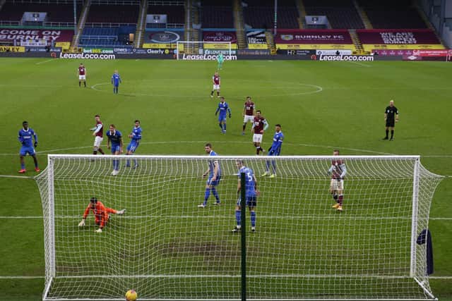 Burnley's Icelandic midfielder Johann Berg Gudmundsson scores their first goal to equalise 1-1 during the English Premier League football match between Burnley and Brighton and Hove Albion at Turf Moor in Burnley, north west England on February 6, 2021.