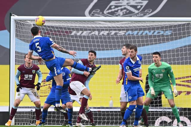 Lewis Dunk of Brighton and Hove Albion scores his team's first goal during the Premier League match between Burnley and Brighton & Hove Albion at Turf Moor on February 06, 2021 in Burnley, England.