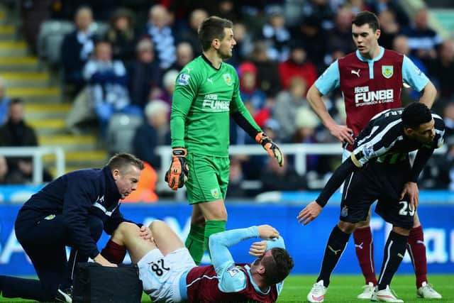 Kevin Long of Burnley receives treatment during the Barclays Premier League match between Newcastle United and Burnley at St James' Park on January 1, 2015 in Newcastle upon Tyne, England.