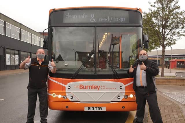 The Burnley Bus Company’s drivers Mark (left) and Shabz remind customers to keep following Government guidance when travelling, including wearing a face covering for the entire journey which covers the nose and mouth.