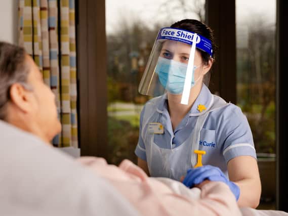 Picture: Phil Hardman
Laura Greensall, Marie Curie Nurse, in PPE, at a Marie Curie Hospice. This picture was taken in January 2021 during the Covid-19 pandemic. Patient posed by a model