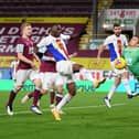 Nick Pope of Burnley saves from Christian Benteke of Crystal Palace during the Premier League match between Burnley and Crystal Palace at Turf Moor on November 23, 2020 in Burnley, England.