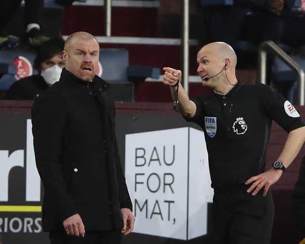 Referee Anthony Taylor (R) talks with Burnley's English manager Sean Dyche (L) during the English Premier League football match between Burnley and Brighton and Hove Albion at Turf Moor in Burnley, north west England on February 6, 2021.