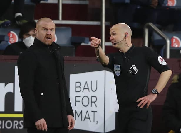 Referee Anthony Taylor (R) talks with Burnley's English manager Sean Dyche (L) during the English Premier League football match between Burnley and Brighton and Hove Albion at Turf Moor in Burnley, north west England on February 6, 2021.