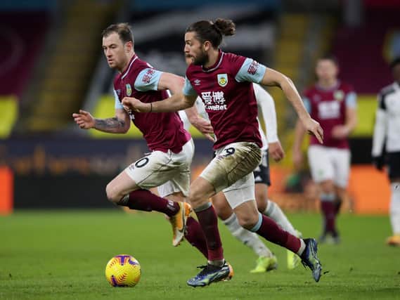 Jay Rodriguez (R) of Burnley runs with the ball with team mate Ashley Barnes during the Premier League match between Burnley and Fulham at Turf Moor on February 17, 2021 in Burnley, England.