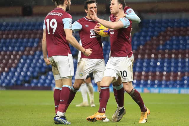 Ashley Barnes of Burnley celebrates with Jay Rodriguez after scoring his team's first goal during the Premier League match between Burnley and Fulham at Turf Moor on February 17, 2021 in Burnley, England.