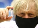 Prime Minister Boris Johnson holding a vial of the Oxford/Astra Zeneca Covid-19 vaccine on February 17, 2021 (Picture: Geoff Caddick/PA Wire)