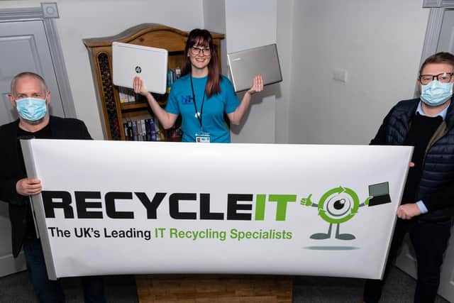 Rio Powell, who is the service delivery director at Healthier Heroes, receives the laptops from Recycle IT's managing director  Rob Doherty and business development manager Carl Greenwood.